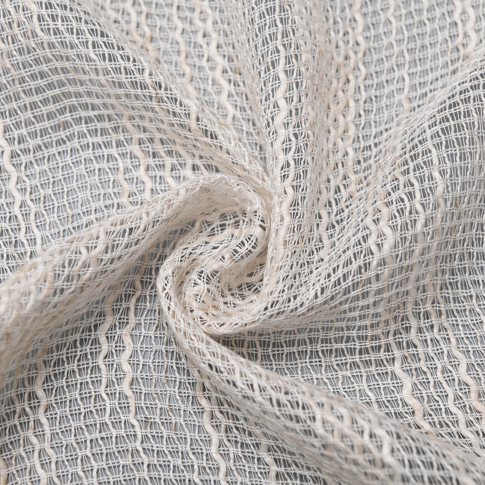 Light beige Theia Linen Sheer Curtains from DWCN Official hanging in a window, showcasing their airy, semi-transparent fabric for elegant privacy.