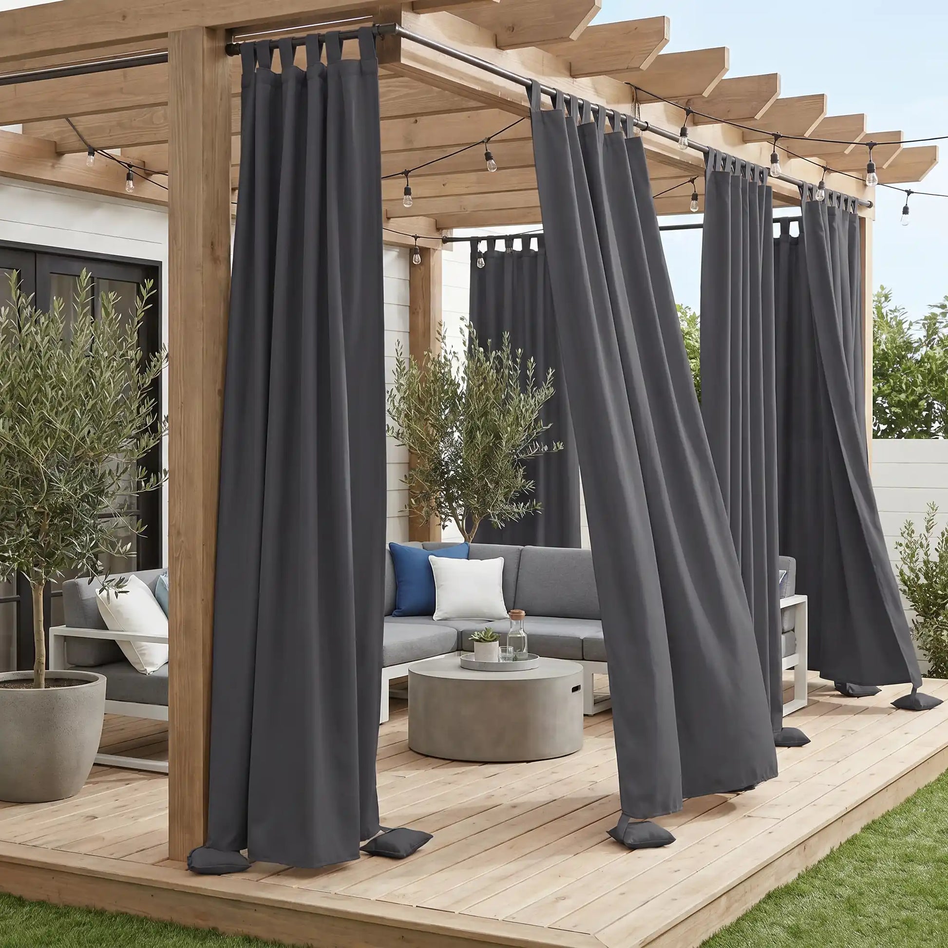 DWCN Official windproof and waterproof outdoor curtain with tab top and weighted bottom for weather-resistant outdoor space.