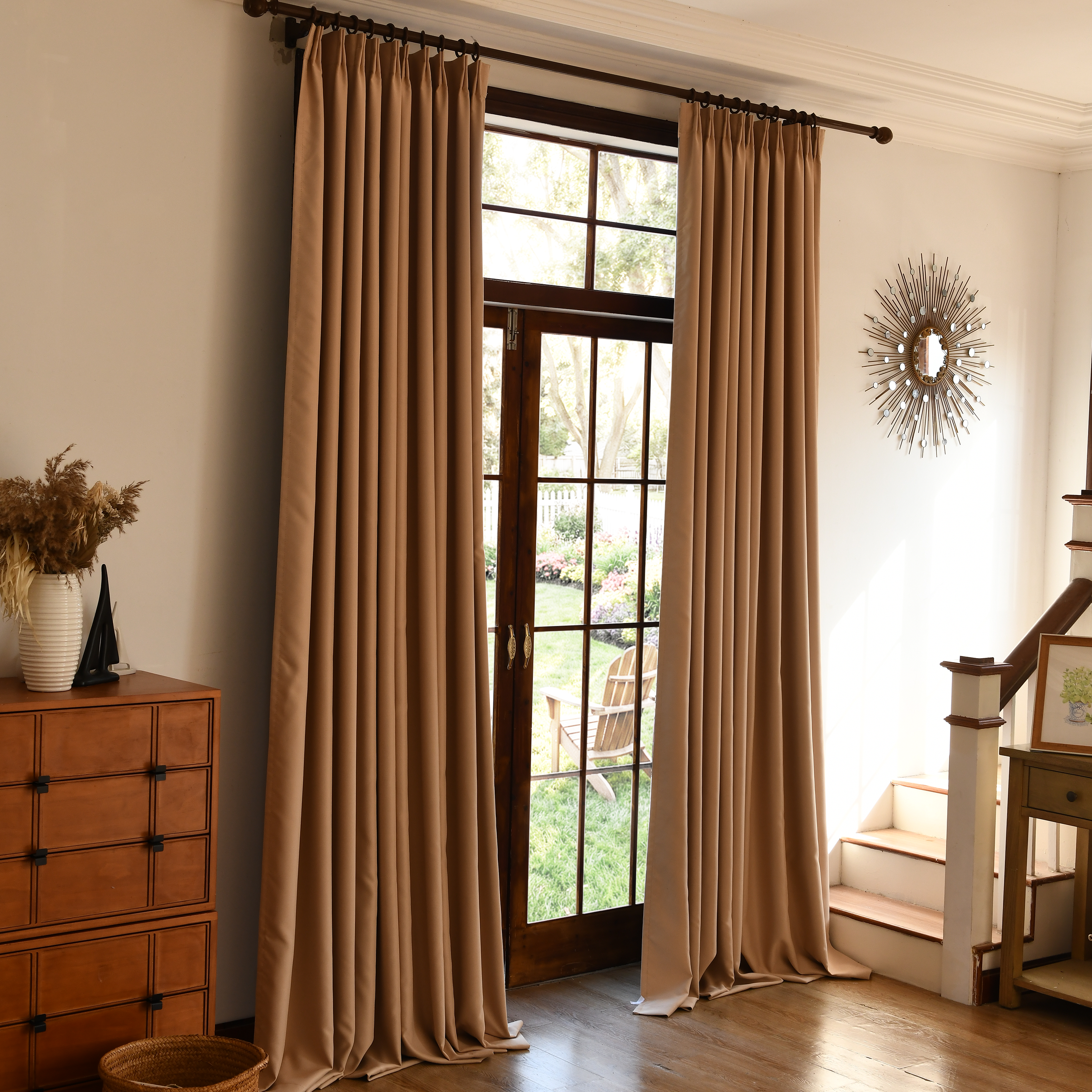 Two black silk-fiber blackout curtains from DWCN Official hanging side by side in a modern living room.