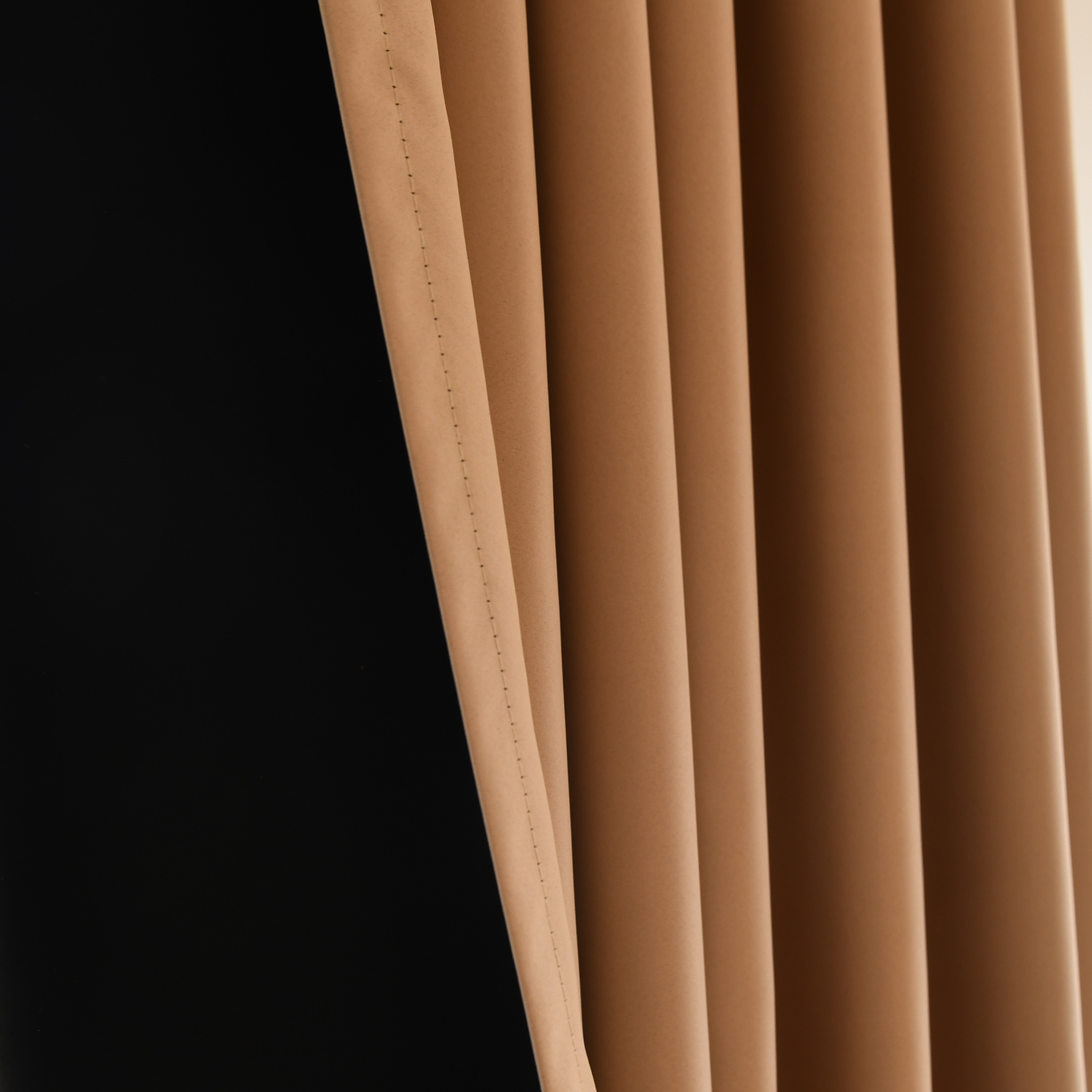 Black silk-fiber curtains from DWCN Official, custom total blackout curtains hanging in a modern window setting.