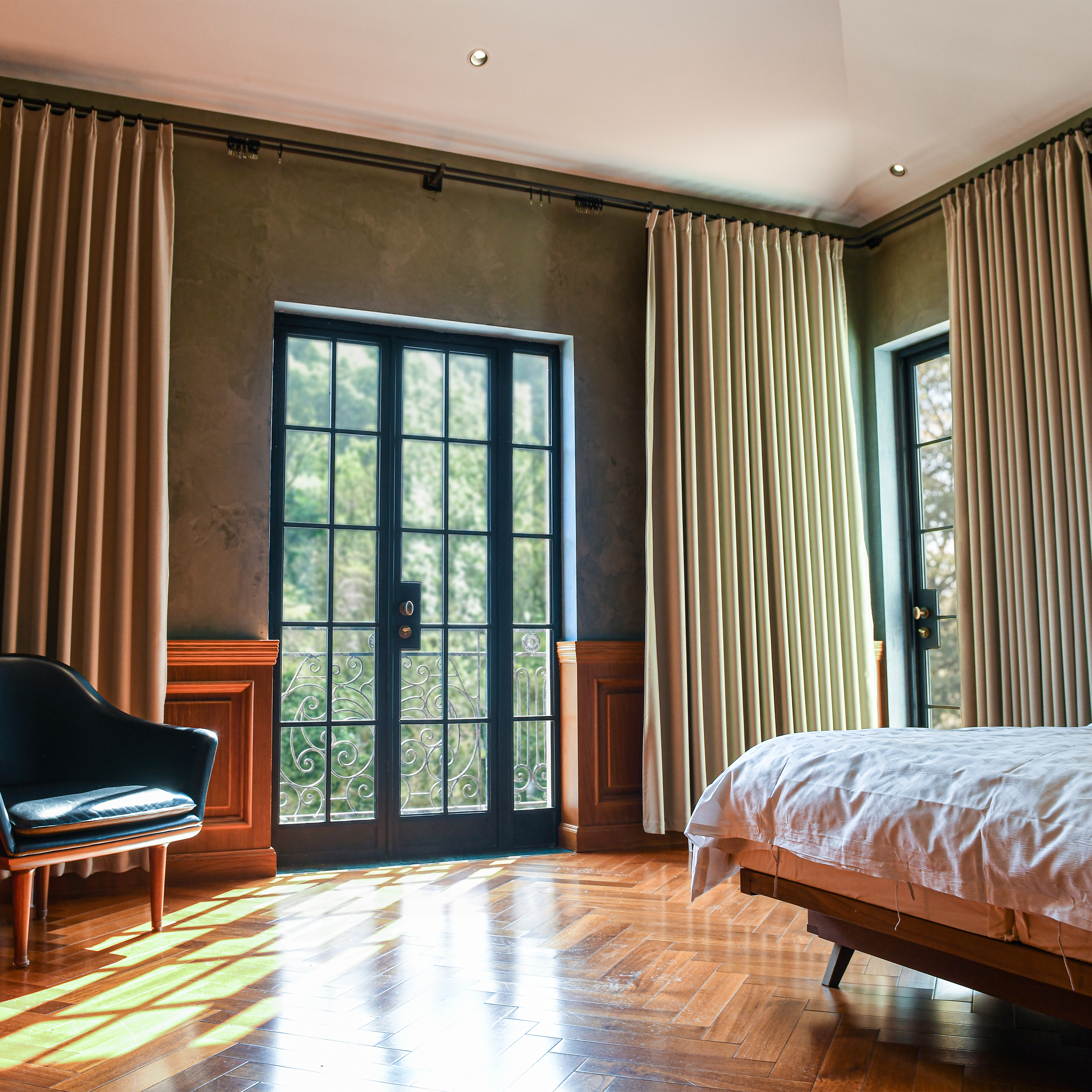 Dark black DWCN official modal heavyweight cotton blackout curtains hanging on a window, blocking light and providing privacy.